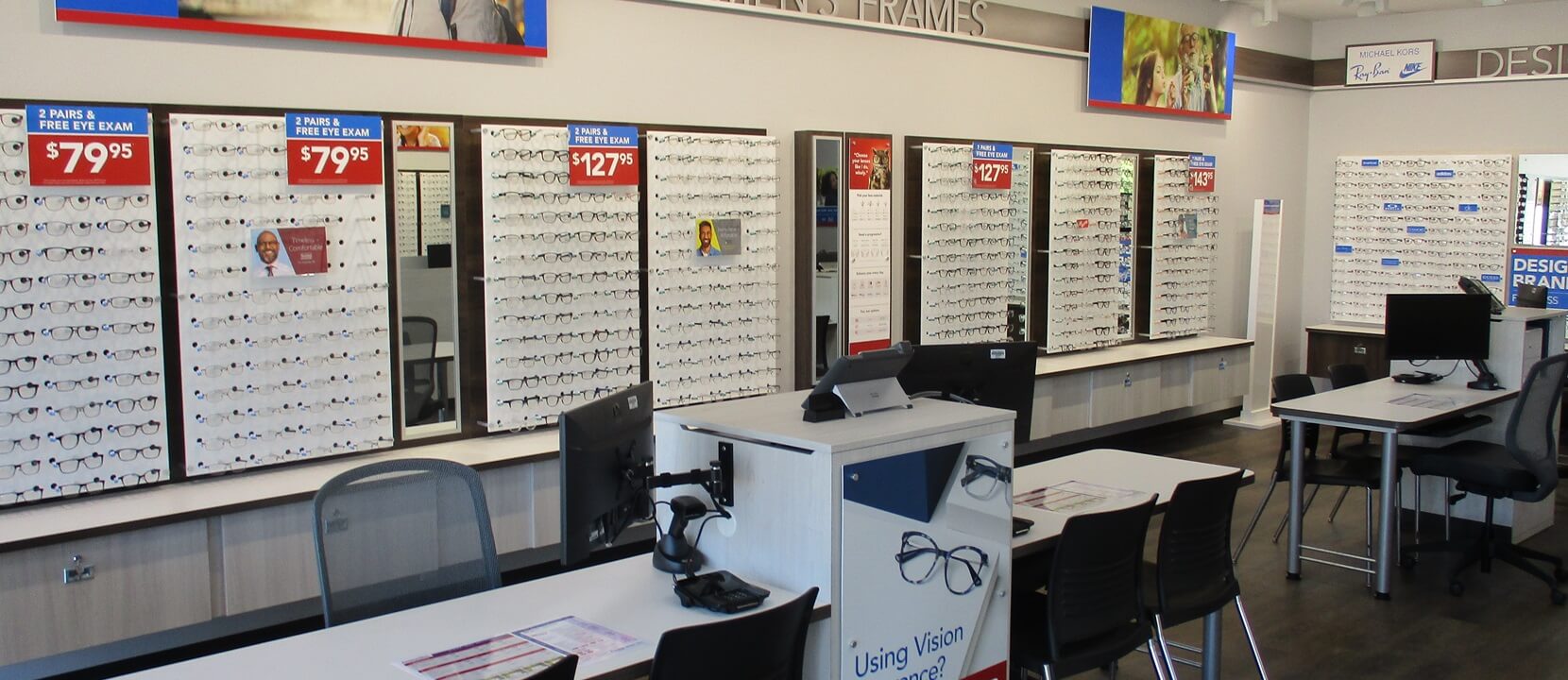 Installation of glasses displays on wall with graphics and signage and installation of new desks and chairs